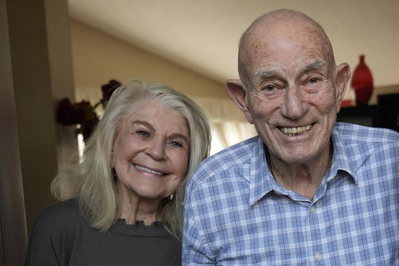 FILE - World War II veteran Harold Terens, 100, right, and Jeanne Swerlin, 96, pose for a photo, Thursday, Feb. 29, 2024, in Boca Raton, Fla. Together, the collective age of the bride and groom was nearly 200. But Terens and his sweetheart Jeanne Swerlin proved that love is eternal as they tied the knot Saturday, June 8, 2024, inland of the D-Day beaches in Normandy, France. (AP Photo/Wilfredo Lee, File)