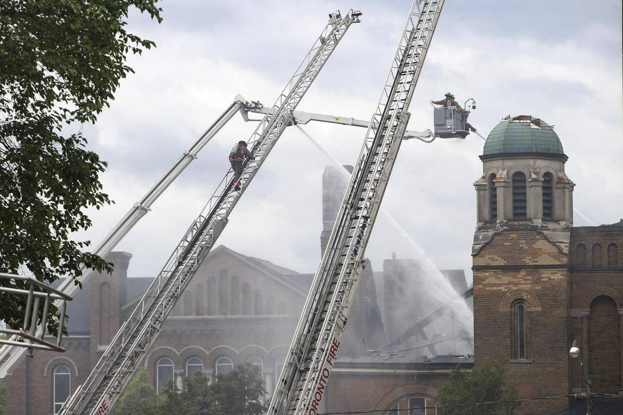 Firefighters work to put out a blaze at St. Anne’s Anglican Church in Toronto’s west end on Sunday, June 9, 2024. THE CANADIAN PRESS/Cole Burston