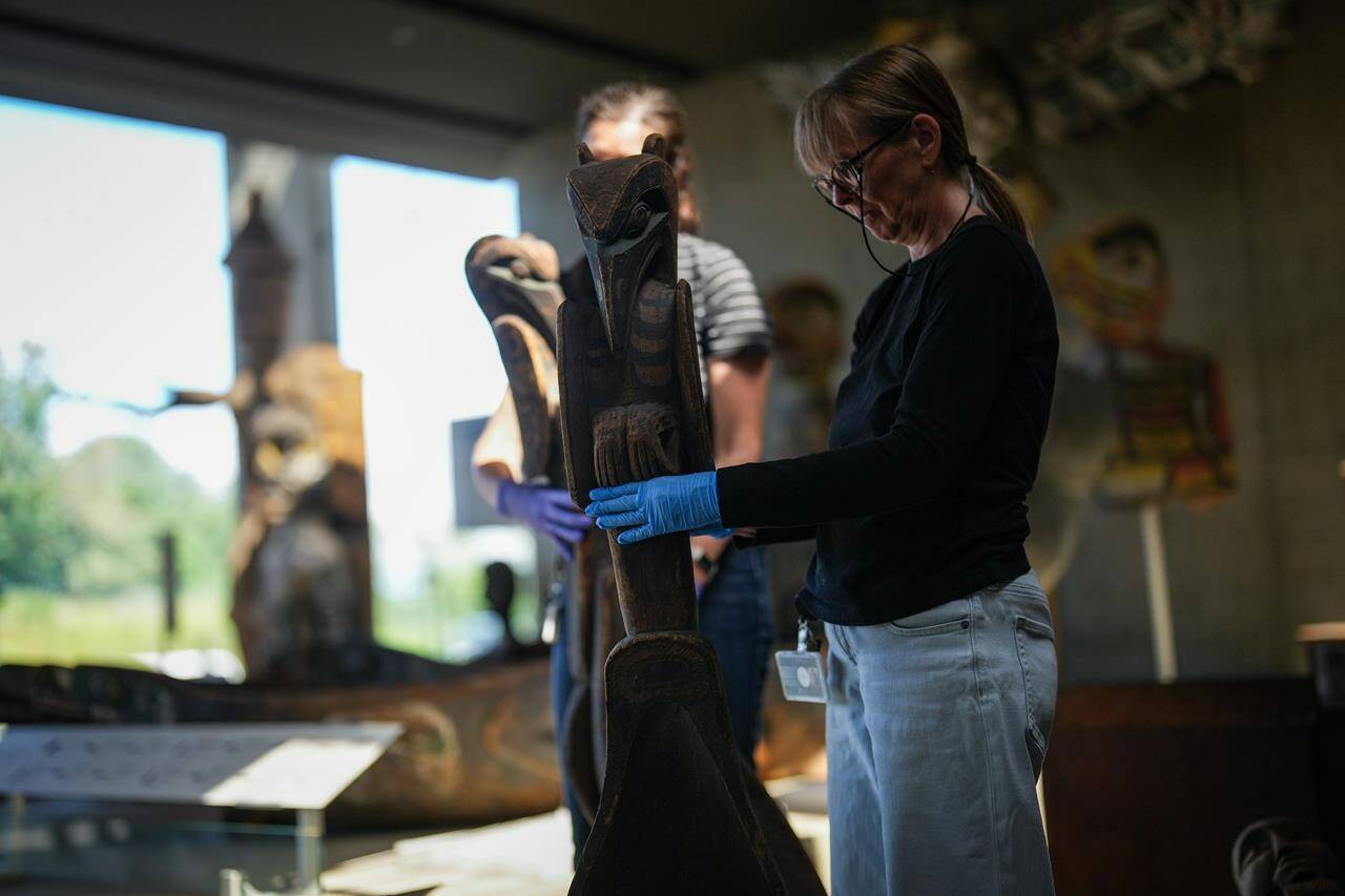 An employee moves a carving as staff and construction workers prepare for the reopening of the Museum of Anthropology, which has been closed for 18 months, in Vancouver, B.C., Tuesday, June 11, 2024. The Great Hall was fully rebuilt with seismic upgrades to protect the collections in the event of a major earthquake. Displays in the gallery spaces have also been revitalized and reinterpreted, in collaboration with First Nations communities and families whose objects and belongings are housed at the museum. THE CANADIAN PRESS/Darryl Dyck