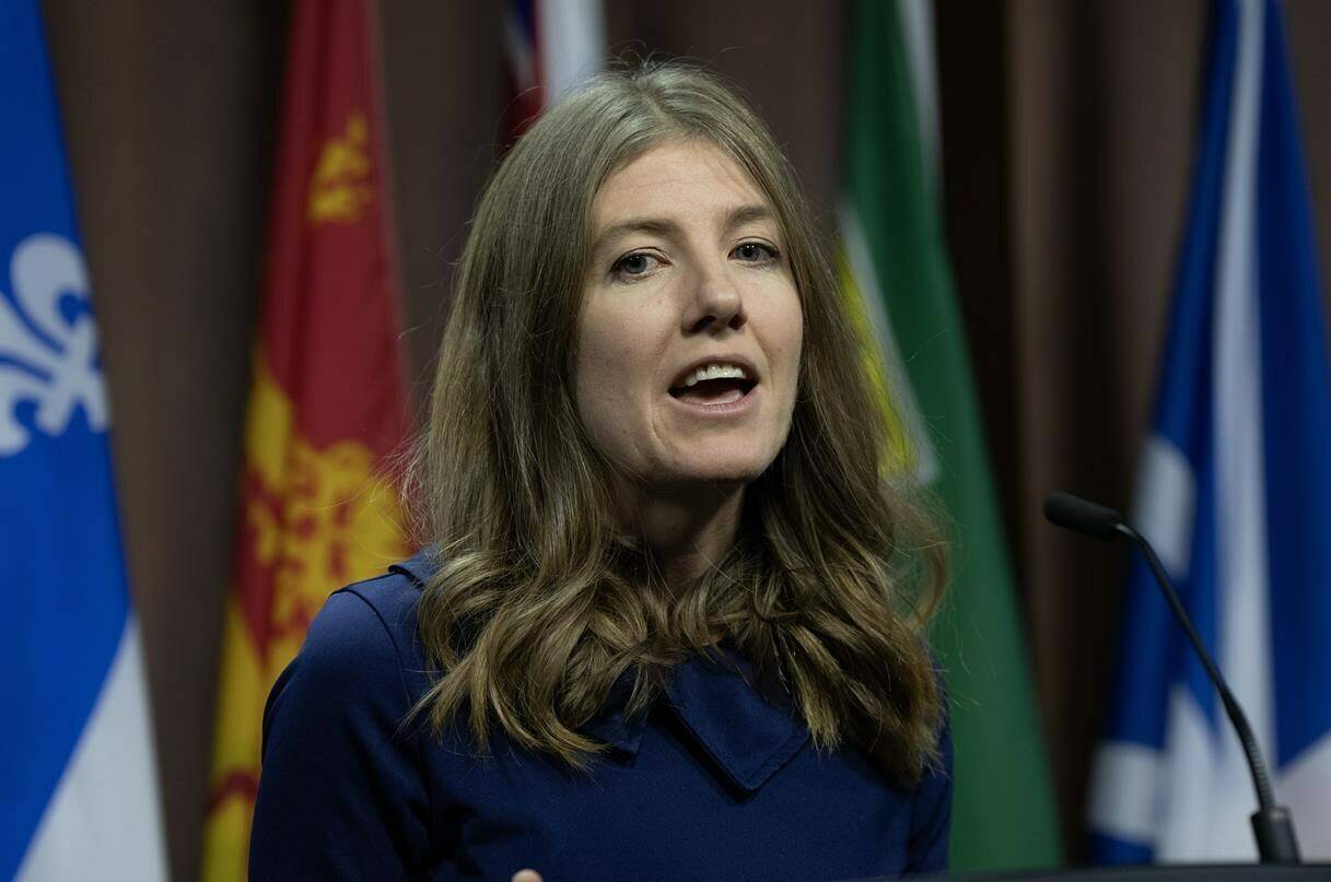 NDP MP for Victoria Laurel Collins makes her way to the podium to speak about a youth corps during a news conference, in Ottawa, Tuesday, Dec. 5, 2023. THE CANADIAN PRESS/Adrian Wyld