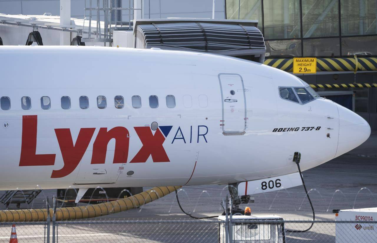 A Lynx Air Boeing 737 jet sits at a gate at the international airport in Calgary on February 23, 2024. THE CANADIAN PRESS/Todd Korol