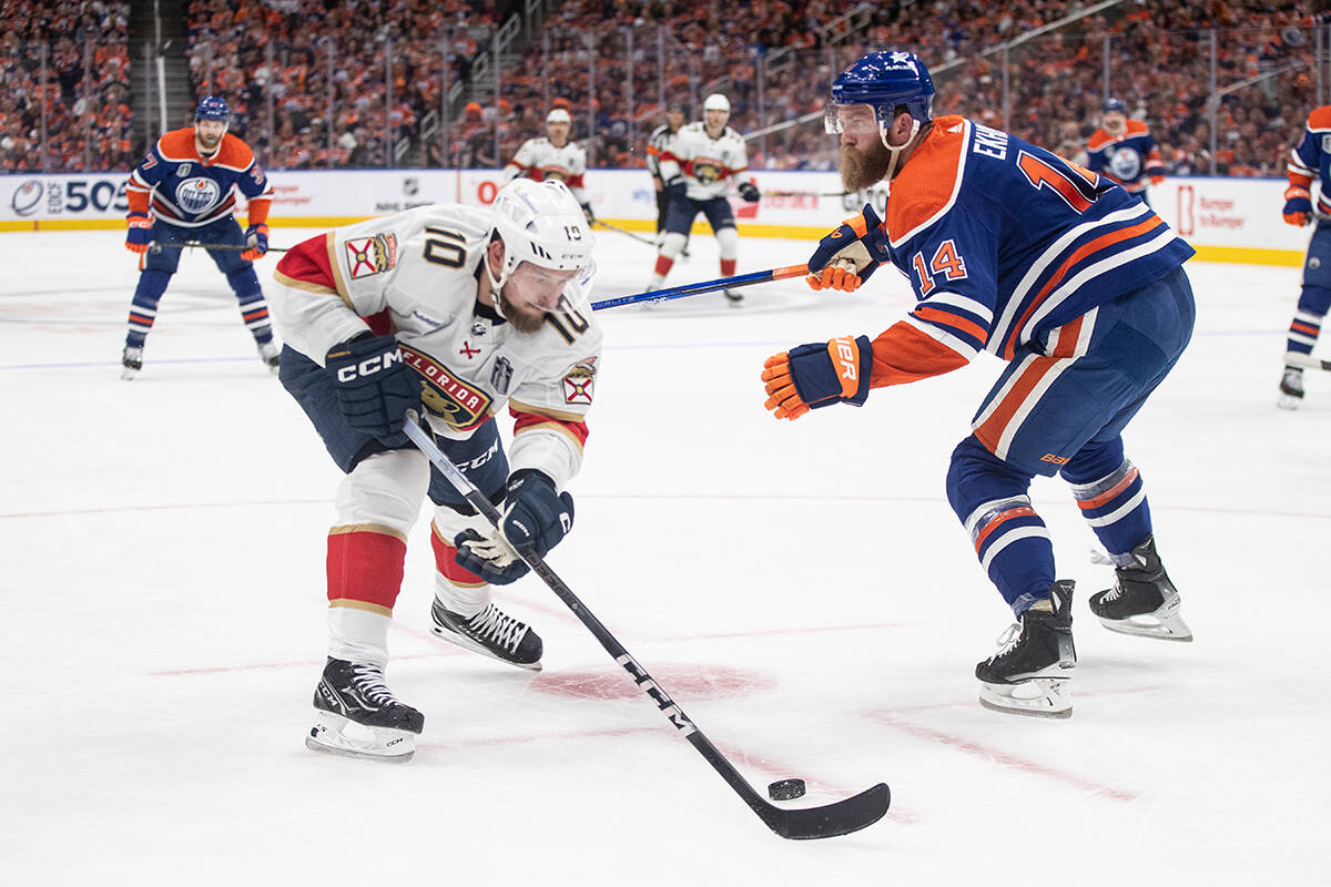 Florida Panthers’ Vladimir Tarasenko (10) and Edmonton Oilers’ Mattias Ekholm (14) battle for the puck during first period Game 4 action of the NHL Stanley Cup final in Edmonton on Saturday June 15, 2024.THE CANADIAN PRESS/Jason Franson