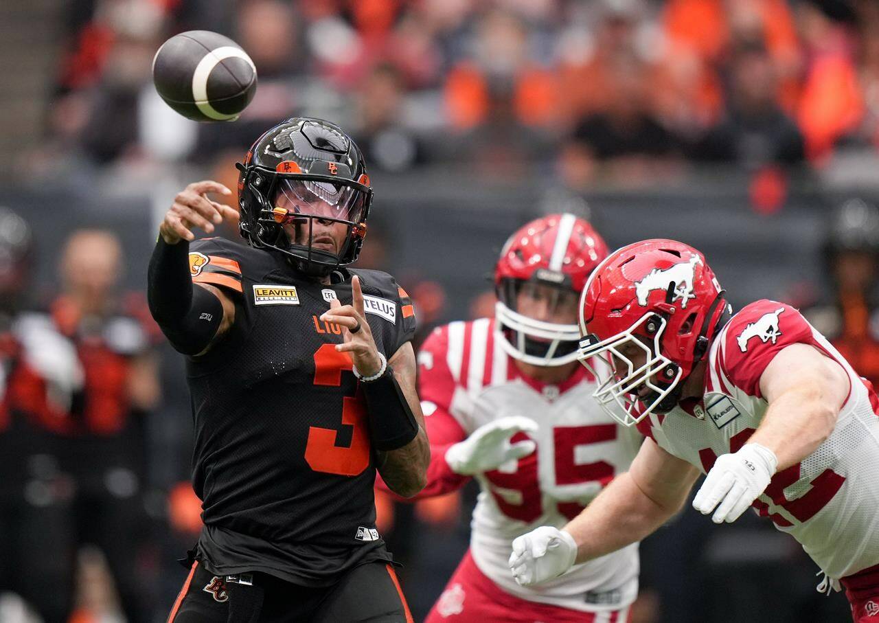 Leading the B.C. Lions to their first win of the season earned quarterback Vernon Adams Jr. the nod as top offensive player on the CFL honour roll Tuesday. Adams Jr., left, passes while being pursued by Calgary Stampeders’ Micah Teitz during the first half of a CFL football game, in Vancouver, on Saturday, June 15, 2024. THE CANADIAN PRESS/Darryl Dyck