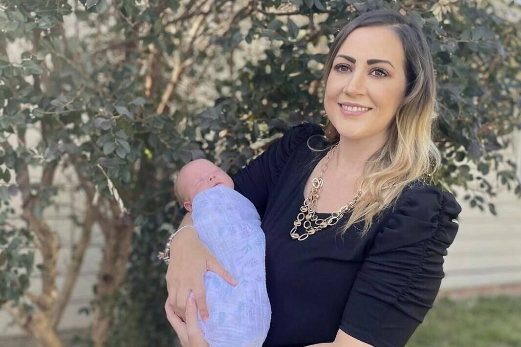 Amanda Harrison holds her baby, Lake, outside her mother’s home in Phenix City, Ala., on Monday, Oct. 18, 2021. Harrison was put on a ventilator and later life support after becoming ill with COVID-19 in her third trimester of pregnancy. Doctors delivered Lake at 32 weeks and put Harrison on a type of life support called extracorporeal membrane oxygenation to save her. Harrison, who was unvaccinated, is urging pregnant women to get vaccinated for COVID-19. (AP Photo/Kim Chandler)