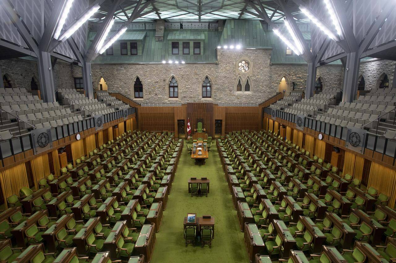 The House of Commons chamber is seen empty, Wednesday, April 8, 2020 in Ottawa. When Parliament resumes on Nov. 22, no one will be allowed into the House of Commons precinct unless they are fully vaccinated against COVID-19. THE CANADIAN PRESS/Adrian Wyld