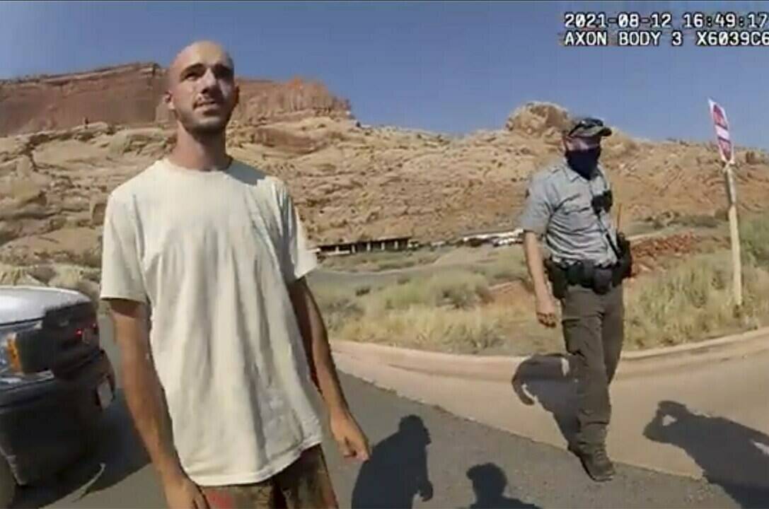 FILE - This Aug. 12, 2021 file photo from video provided by The Moab Police Department shows Brian Laundrie talking to a police officer after police pulled over the van he was traveling in with his girlfriend, Gabrielle “Gabby” Petito, near the entrance to Arches National Park. Laundrie, the boyfriend of Gabby Petito, whose body was found at a national park in Wyoming after a cross-country trip with him, has been charged with unauthorized use of a debit card as searchers continue looking for him in Florida swampland, federal authorities announced Thursday, Sept. 23, 2021. (The Moab Police Department via AP, File)