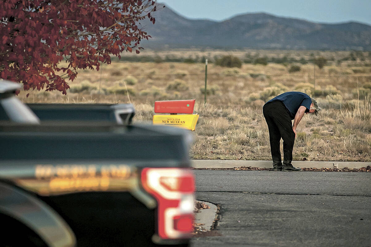 A distraught Alec Baldwin lingers in the parking lot outside the Santa Fe County Sheriff’s Office in Santa Fe, N.M., after he was questioned about a shooting on the set of the film “Rust” on the outskirts of Santa Fe, Thursday, Oct. 21, 2021. Baldwin fired a prop gun on the set, killing cinematographer Halyna Hutchins and wounding director Joel Souza, officials said. (Jim Weber/Santa Fe New Mexican via AP)