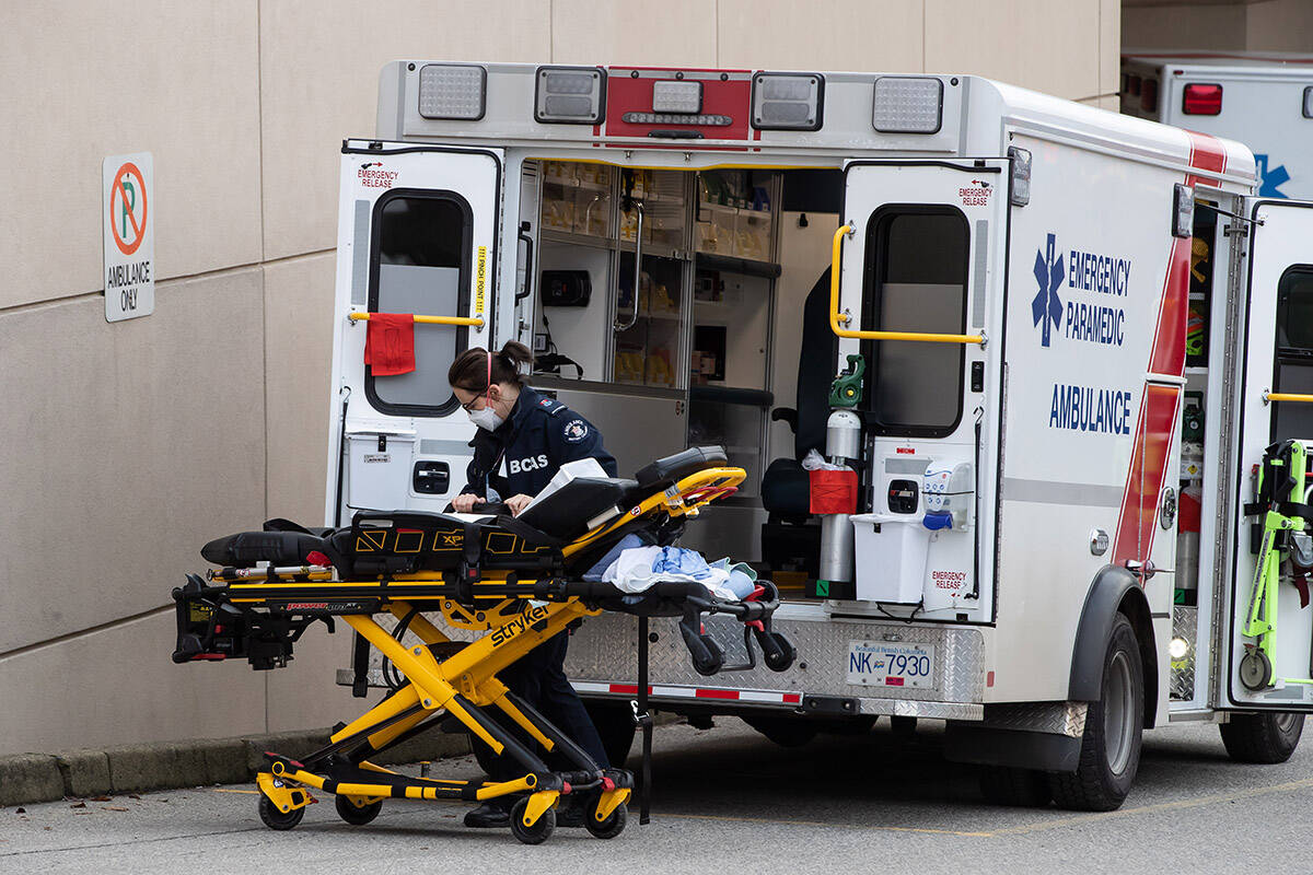 A B.C. Ambulance Service paramedic wearing a face mask to curb the spread of COVID-19 moves a stretcher outside an ambulance at Royal Columbia Hospital, in New Westminster, B.C., on Sunday, November 29, 2020. THE CANADIAN PRESS/Darryl Dyck