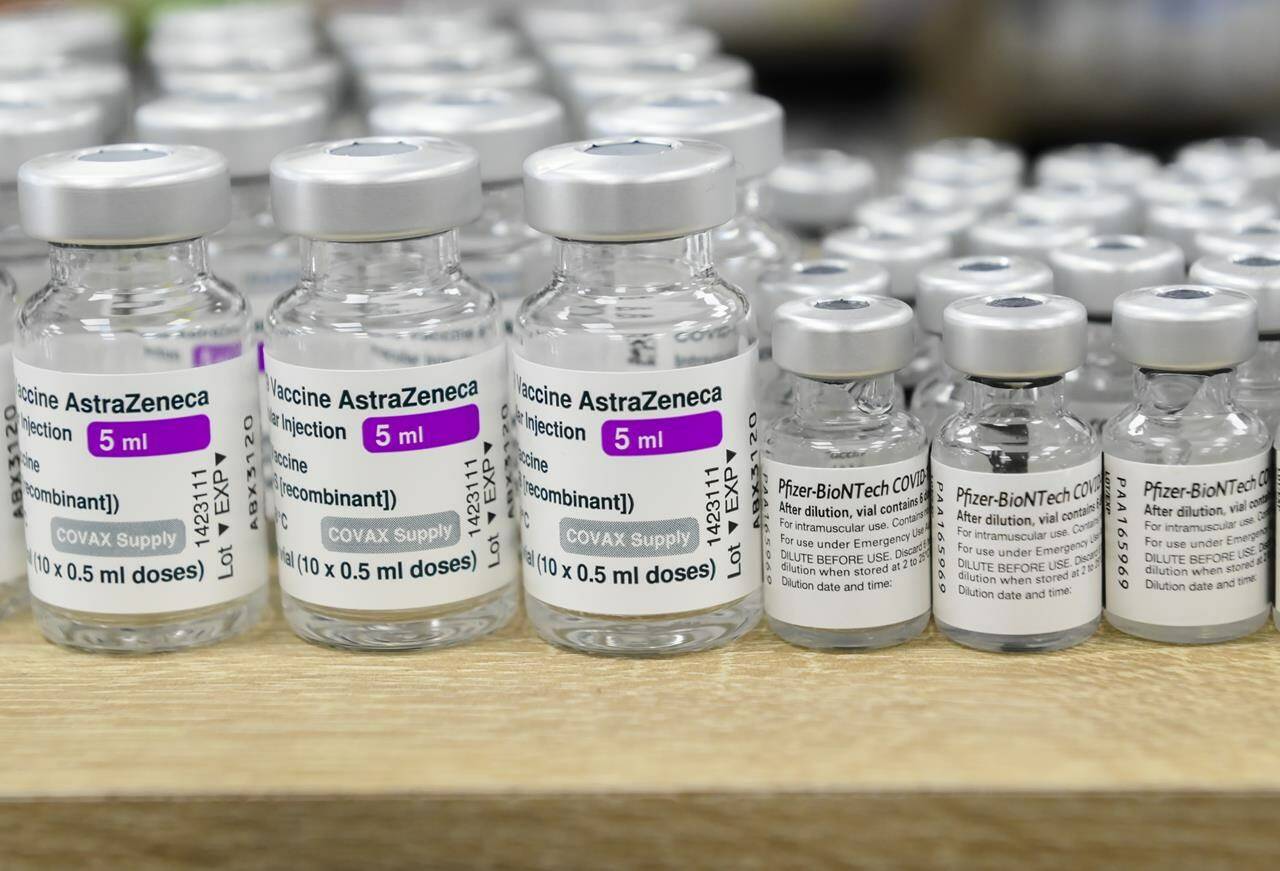 Vials of both Pfizer-BioNTech and Oxford-AstraZeneca COVID-19 vaccines sit empty on the counter at the Junction Chemist Pharmacy in Toronto on Friday, June 18, 2021. THE CANADIAN PRESS/Nathan Denette