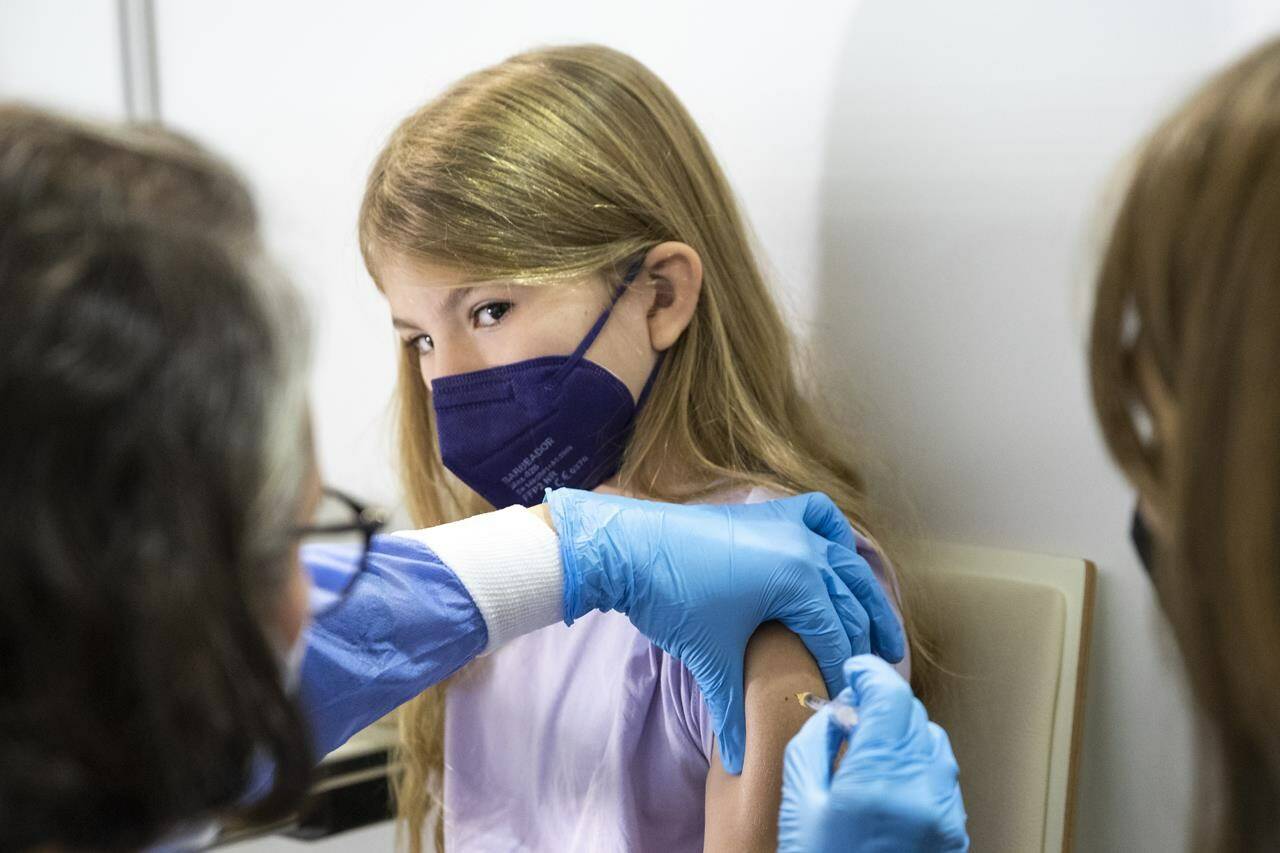 A young patient receives the Pfizer-BioNTech vaccine against COVID-19 in Vienna, Austria on Monday, Nov. 15, 2021. THE CANADIAN PRESS/AP-Lisa Leutner