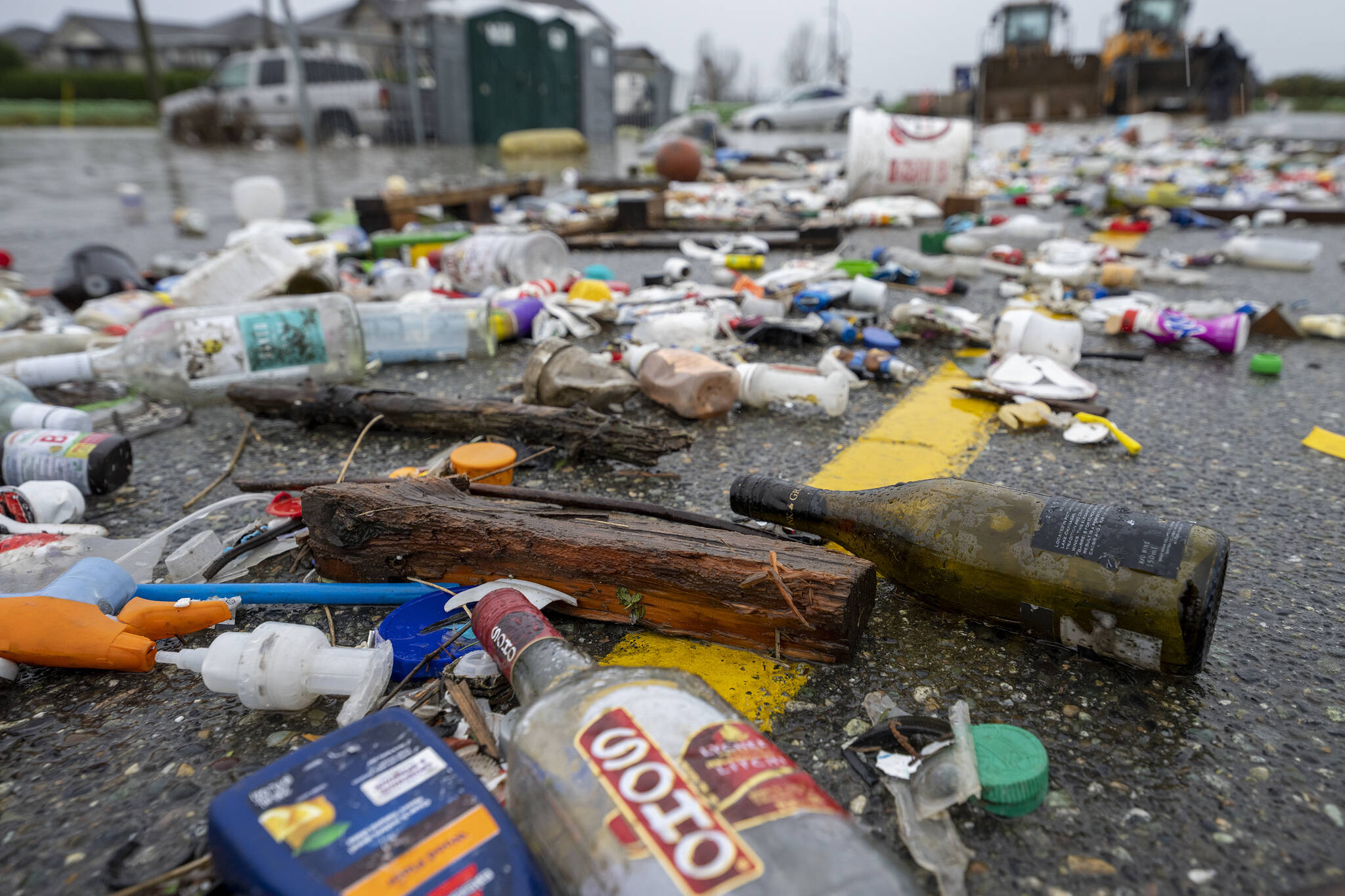 Debris from receding flood waters is pictured along a road as heavy rains form an atmospheric river continue in Abbotsford, B.C., Tuesday, November 30, 2021. THE CANADIAN PRESS/Jonathan Hayward