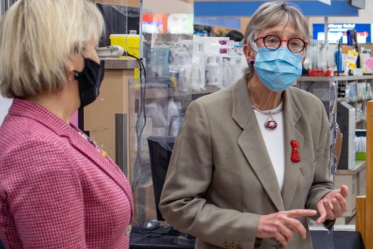 Provincial health officer Dr. Bonnie Henry and Dr. Penny Ballem, head of B.C.’s COVID-19 vaccination program, announce that pharmacies are taking part in the province’s booster campaign, Dec. 14, 2021. (B.C. government photo)