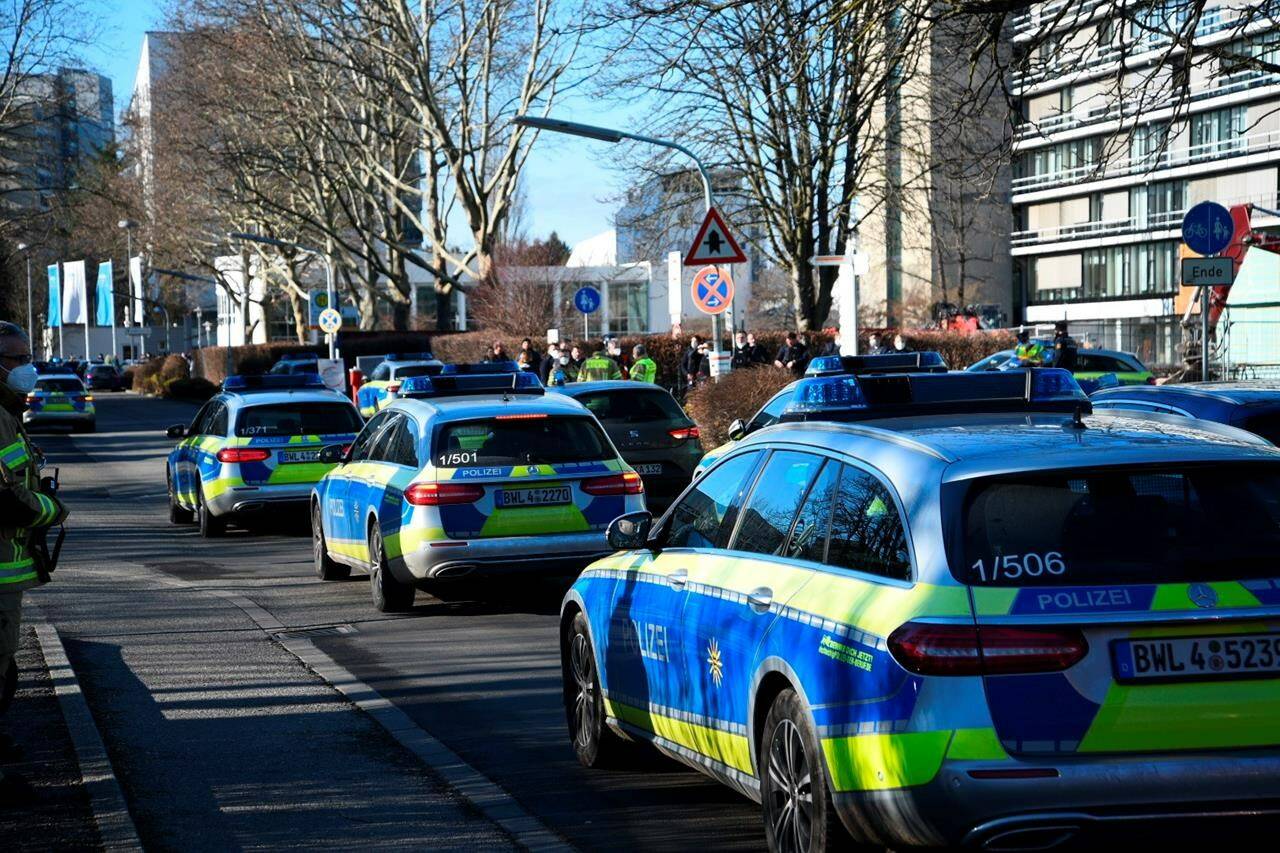 Police vehicles are parked on the grounds of Heidelberg University in Heidelberg, Germany, Monday, Jan. 24, 2022. German police say a lone gunman wounded several people at a lecture theatre in the southwest city of Heidelberg on Monday. Police said in a brief statement that the perpetrator was dead but didn’t give details of how that happened. (R.Priebe/Pr-Video/dpa via AP)