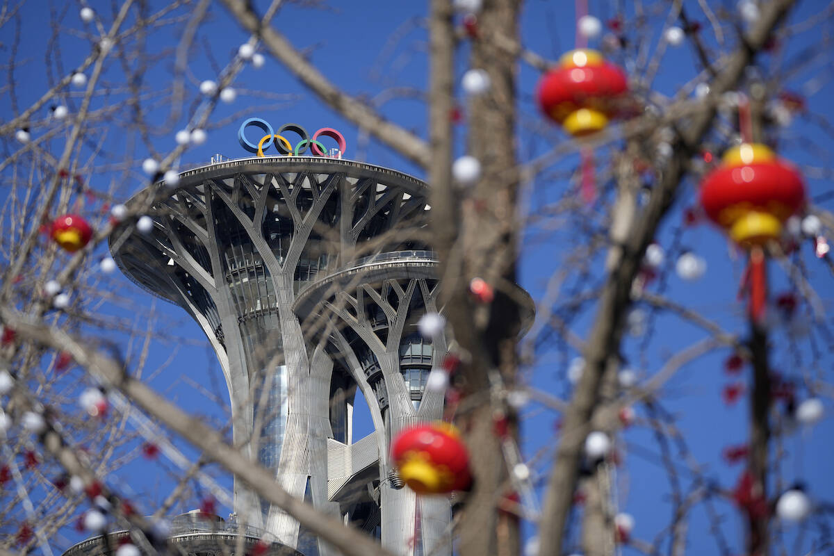 Lantern decorations are hung on trees on the Olympic Green near the Olympic Tower at the 2022 Winter Olympics, Tuesday, Feb. 1, 2022, in Beijing. Millions of people in China and beyond are celebrating the Lunar New Year holiday on Tuesday. (AP Photo/Mark Schiefelbein)