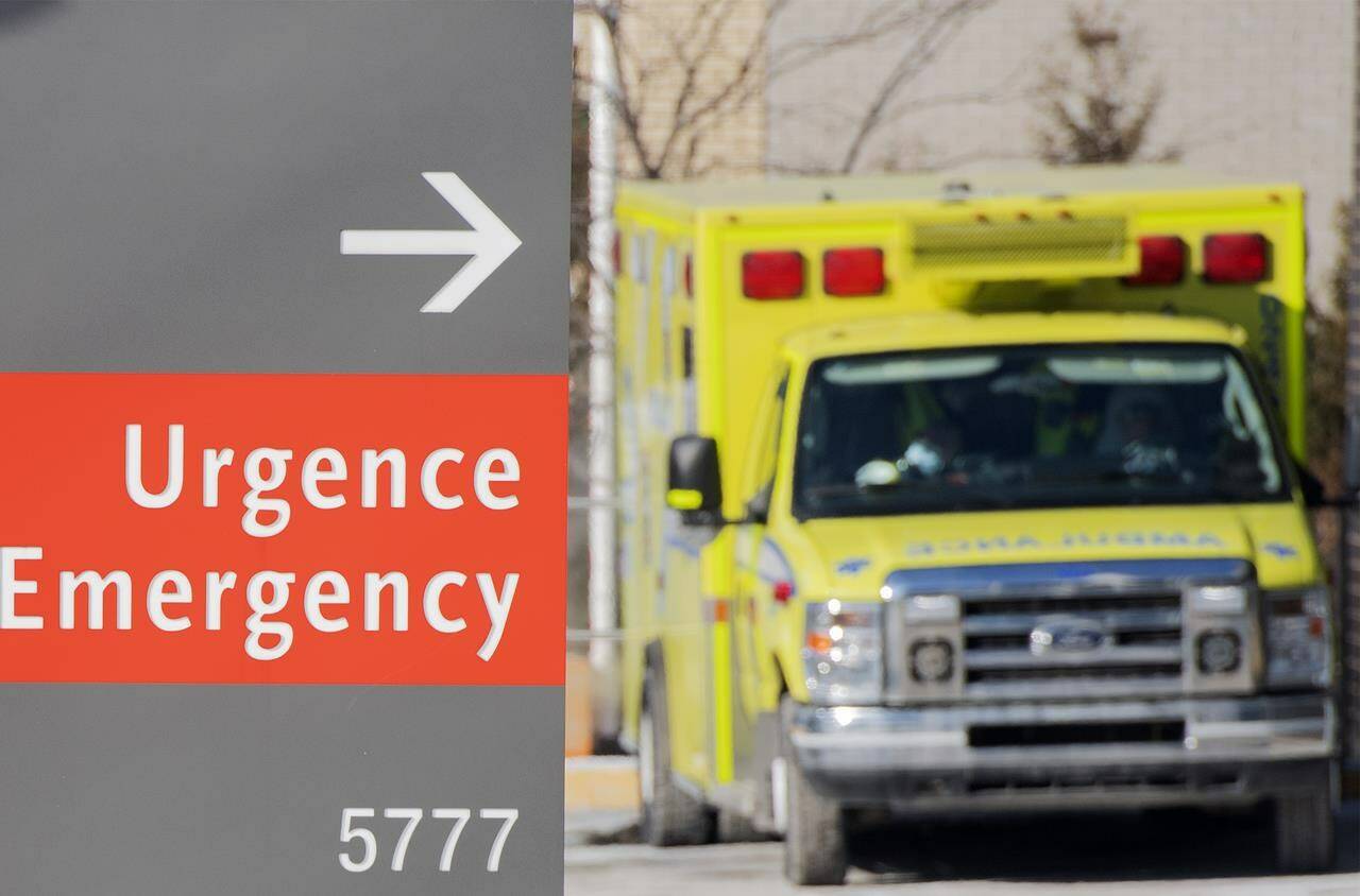 An ambulance is shown outside a hospital in Montreal, Saturday, Jan. 15, 2022, as the COVID-19 pandemic continues in Canada. THE CANADIAN PRESS/Graham Hughes