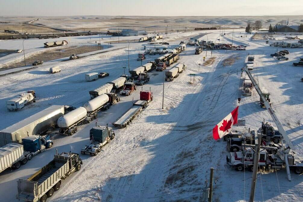 A truck convoy of anti-COVID-19 vaccine mandate demonstrators continues to block the highway at the busy U.S. border crossing in Coutts, Alta., Wednesday, Feb. 2, 2022. THE CANADIAN PRESS/Jeff McIntosh