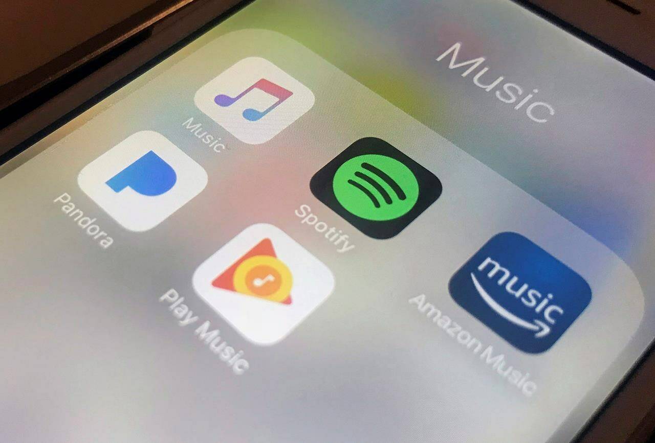 This Sunday, Jan. 28, 2018, photo shows music streaming apps clockwise from top left, Apple, Spotify, Amazon, Pandora and Google on an iPhone in New York. SOCAN has revealed that on average Canadian sogwriters earned only $67 last year in royalties from digital streaming services.THE CANADIAN PRESS/AP-Jenny Kane