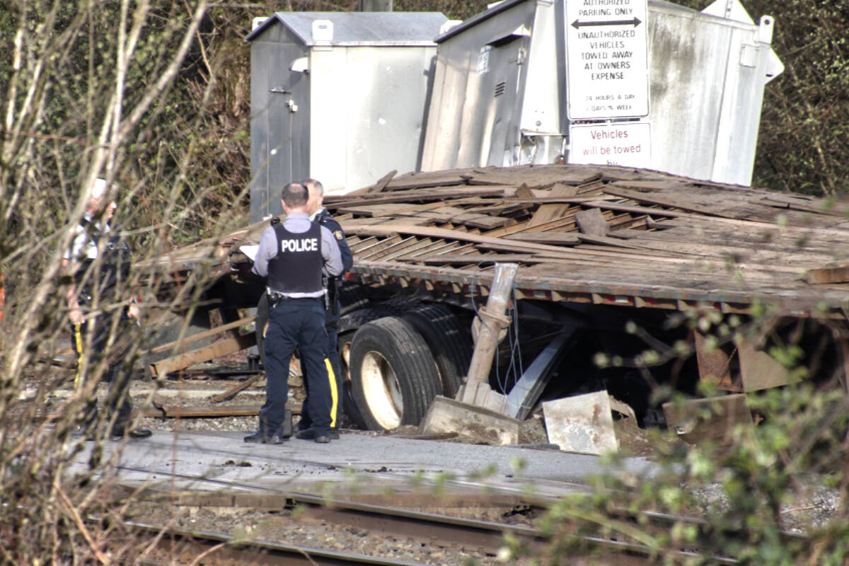 Police, firefighters, and paramedics were all on scene of a reported fatal crash involving a train, a semi, and an SUV on Thursday evening, April 21, 2022. (Shane MacKichan/Special to the News)