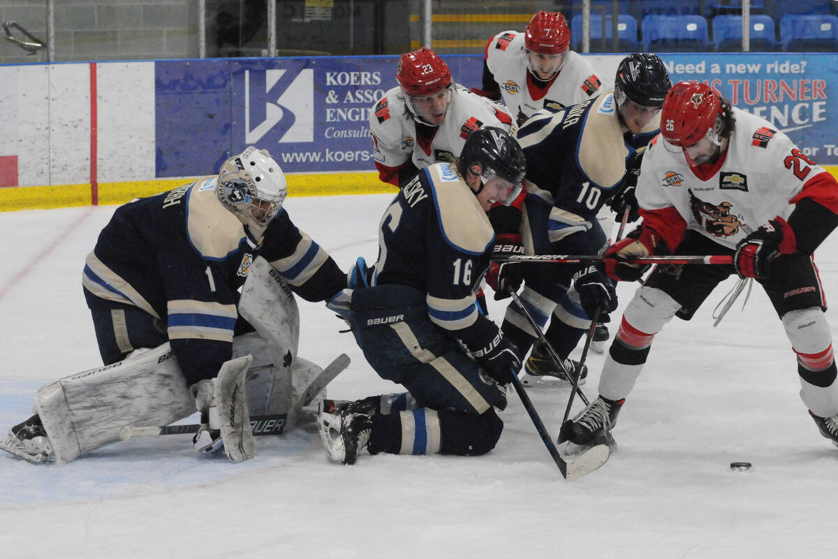 Alberni Valley Bulldogs’ Ethan Leyer, right, tries to get his stick on the puck in front of Langley Rivermen goalie Ajeet Gundarah in the third period of Game 5 of the BC Hockey League Coastal Conference semifinal, April 22, 2022 in Port Alberni. (SUSAN QUINN/ Alberni Valley News)