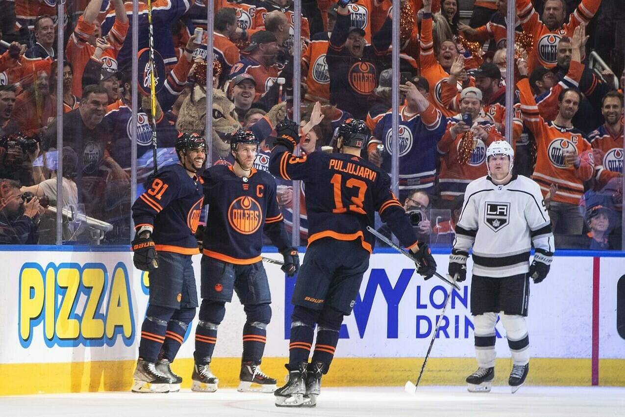 Los Angeles Kings’ Carl Grundstrom (91) looks on as Edmonton Oilers’ Evander Kane (91), Connor McDavid (97) and Jesse Puljujarvi (13) celebrate a goal during third period NHL playoff action in Edmonton on Wednesday, May 4, 2022.THE CANADIAN PRESS/Jason Franson