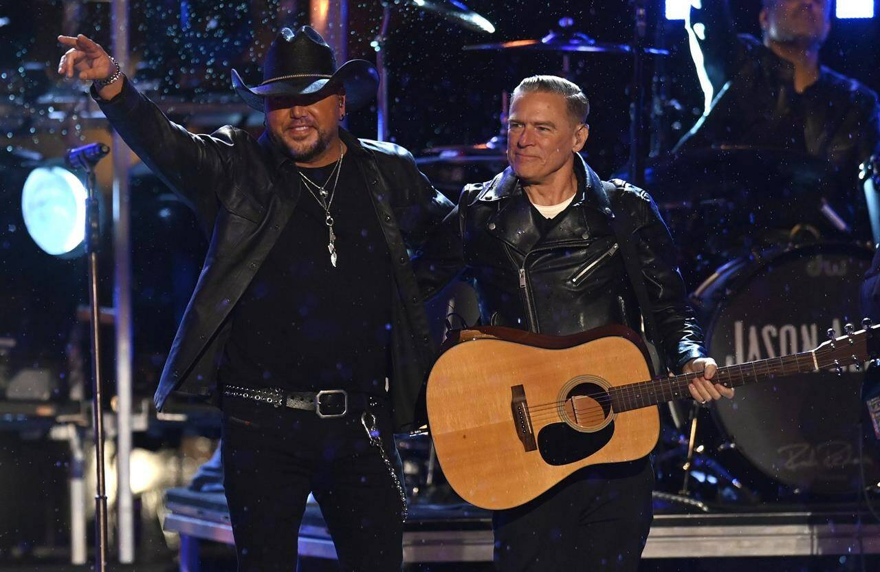 Jason Aldean, left, and Bryan Adams perform “Heaven” at the CMT Music Awards on Monday, April 11, 2022, in Nashville, Tenn. Adams is hitting the road in Canada with a cross-country tour set for later this summer. (AP Photo/Mark Zaleski)