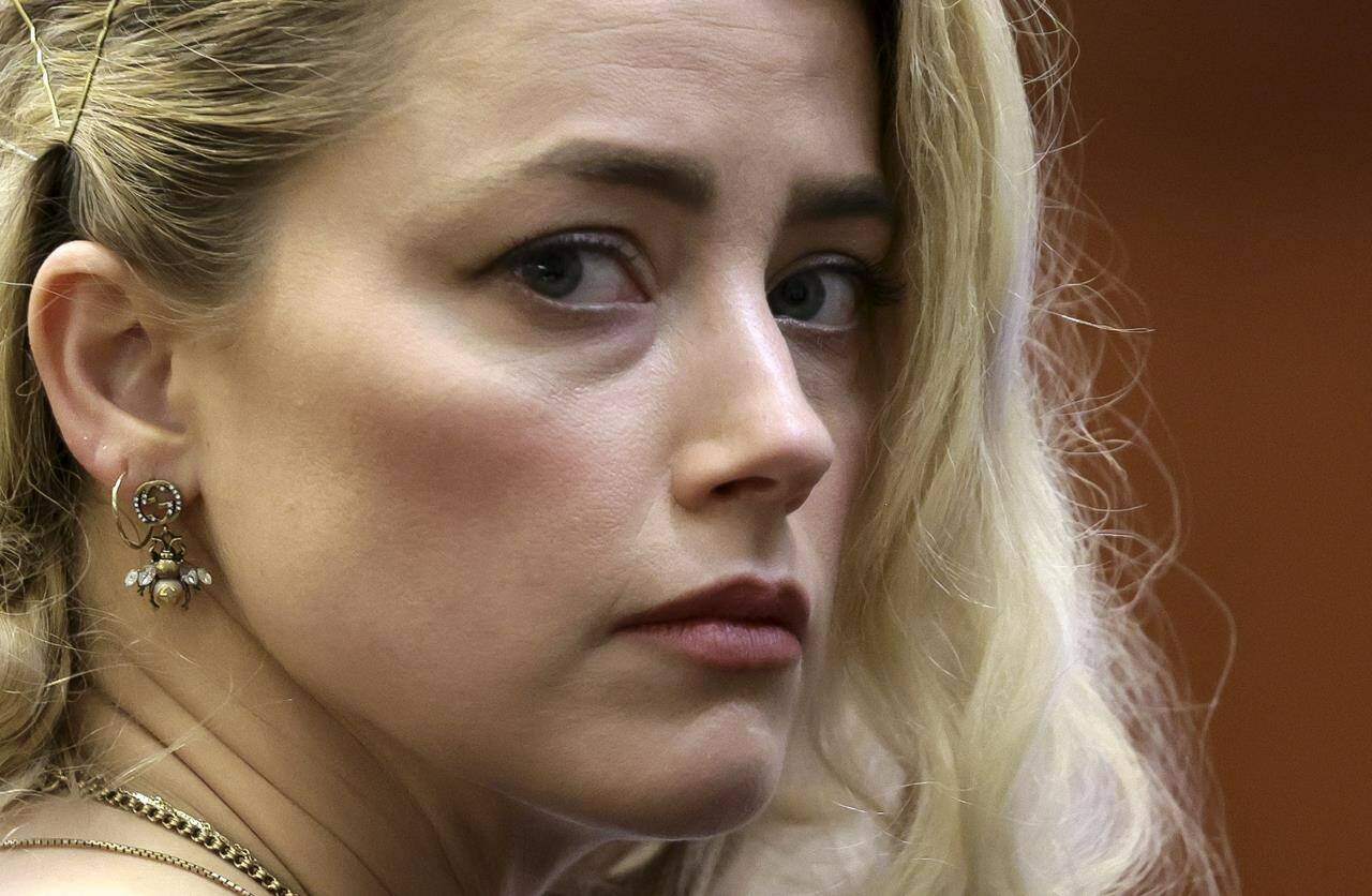 Actor Amber Heard waits before the verdict was read at the Fairfax County Circuit Courthouse in Fairfax, Va, Wednesday, June 1, 2022. The jury awarded Johnny Depp more than $10 million in his libel lawsuit against ex-wife Amber Heard. It vindicates his stance that Heard fabricated claims that she was abused by Depp before and during their brief marriage. But the jury also found in favor of Heard, who said she was defamed by a lawyer for Depp.(Evelyn Hockstein/Pool via AP)