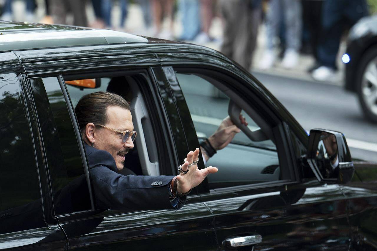 Actor Johnny Depp waves to supporters as he departs Fairfax County Courthouse Friday, May 27, 2022 in Fairfax, Va, A jury heard closing arguments in Johnny Depp’s high-profile libel lawsuit against ex-wife Amber Heard. Lawyers for Johnny Depp and Amber Heard made their closing arguments to a Virginia jury in Depp’s civil suit against his ex-wife.(AP Photo/Craig Hudson)