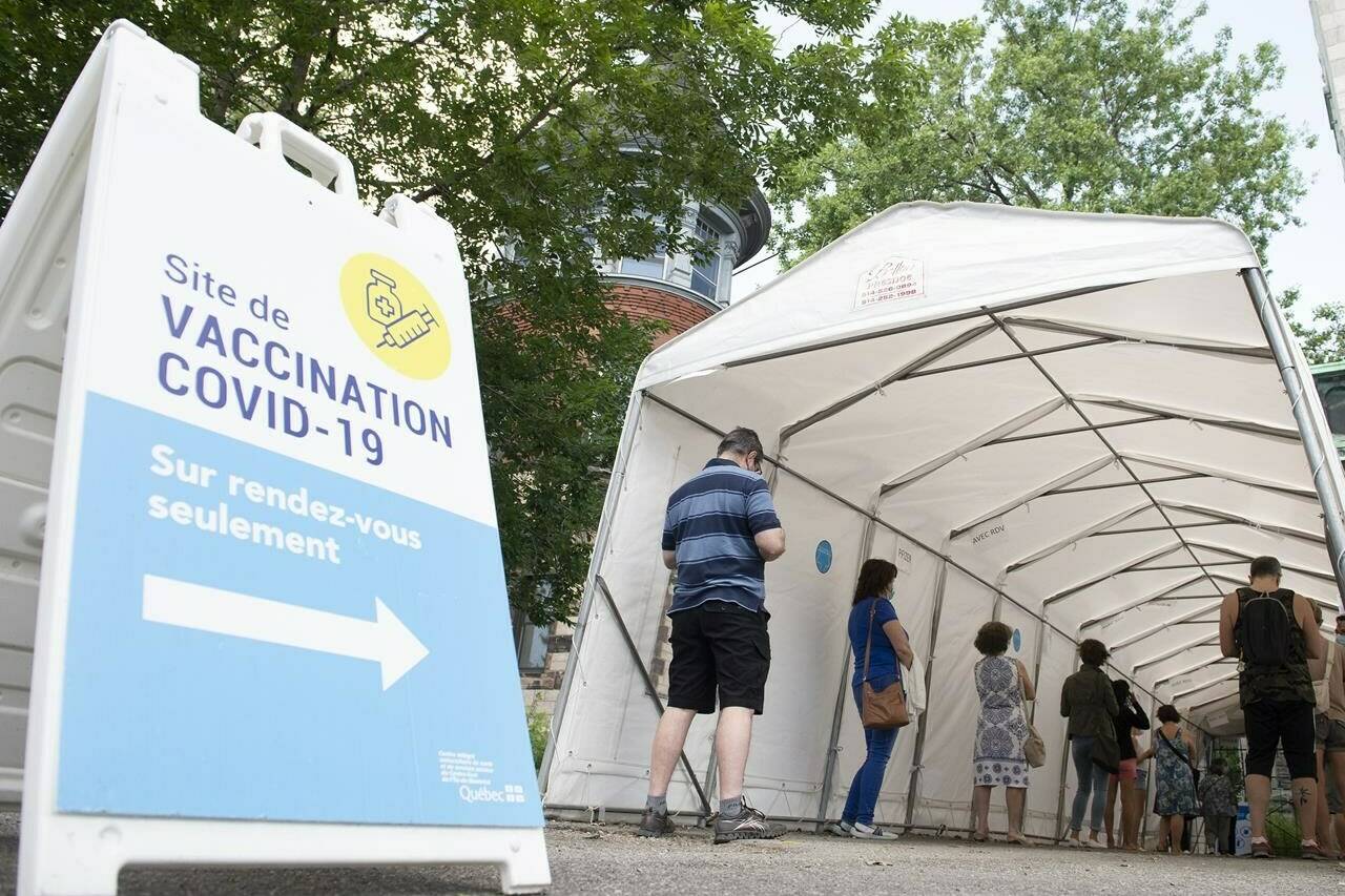 Canada handled the first two years of the COVID-19 pandemic and weathered the ensuing upheaval better than several other nations with comparable health-care and economic infrastructure, a new study suggests. People wait in line to receive a COVID-19 vaccine in Montreal, Saturday, June 19, 2021. THE CANADIAN PRESS/Graham Hughes