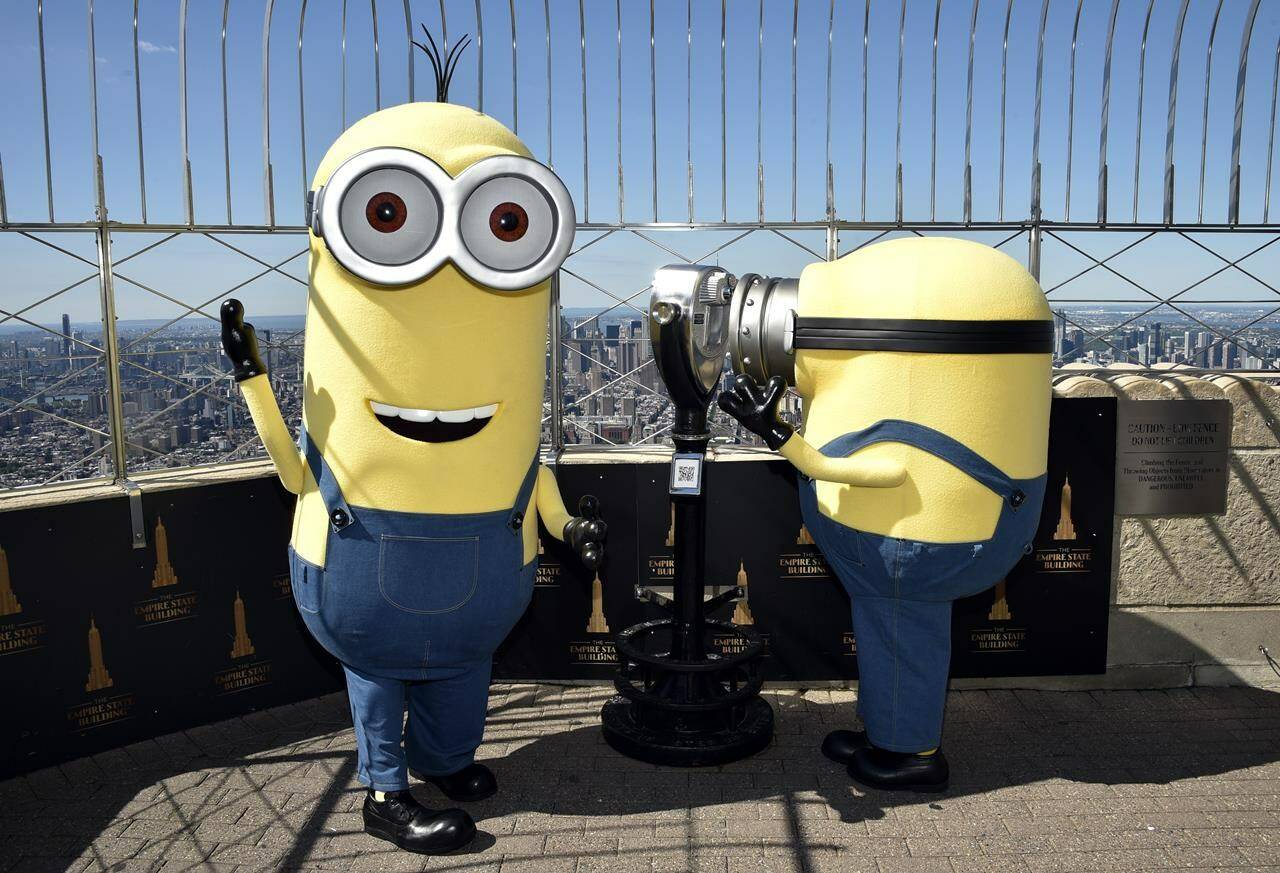 Minion characters Kevin, left, and Bob pose on the 86th floor observatory deck at the Empire State Building to celebrate the upcoming film “Minions: The Rise of Gru” on Tuesday, June 28, 2022, in New York. (Photo by Evan Agostini/Invision/AP)