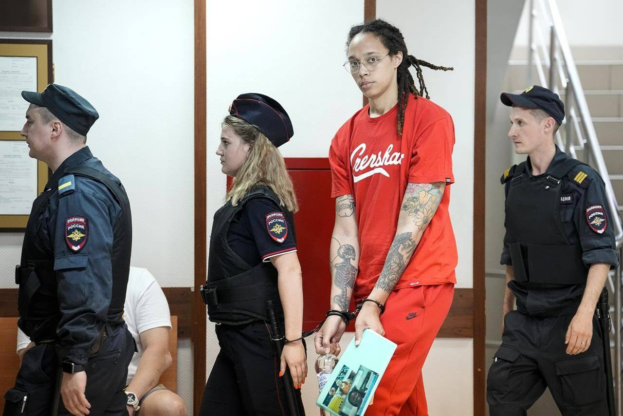 FILE - WNBA star and two-time Olympic gold medalist Brittney Griner is escorted to a courtroom for a hearing, in Khimki outside Moscow, Russia, Thursday, July 7, 2022. Closing arguments in Brittney Griner’s cannabis possession case in Russia are set for Thursday. That’s nearly six months after the American basketball star was arrested at a Moscow airport in a case that has reached the highest levels of U.S.-Russia diplomacy. (AP Photo/Alexander Zemlianichenko, File)