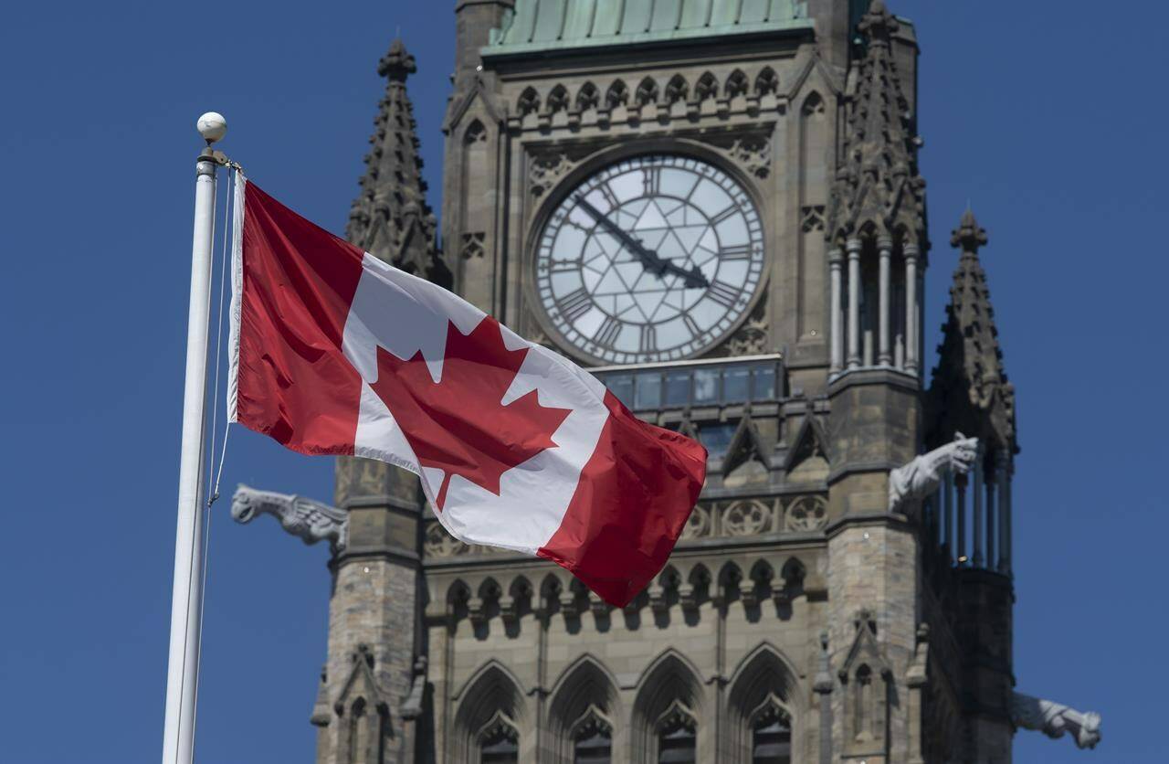 The Canadian flag flies near the Peace tower on Parliament Hill in Ottawa. THE CANADIAN PRESS/Adrian Wyld