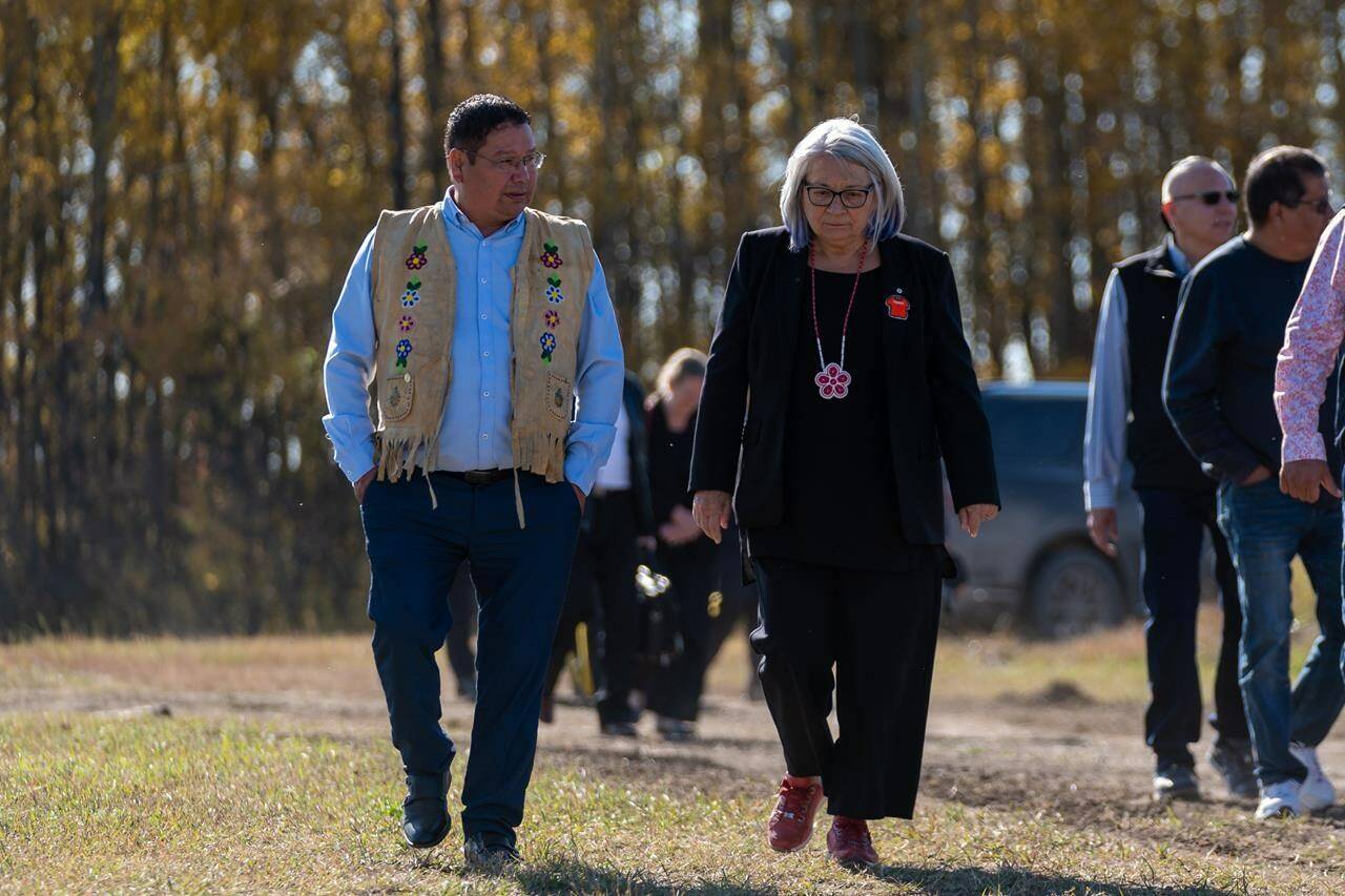 Gov.-Gen. Mary Simon, right, and Chief Wally Burns of James Smith Cree Nation walk during their visit the victims’ gravesite of the mass stabbing incident at James Smith Cree Nation, Sask., on Wednesday, September 28, 2022. THE CANADIAN PRESS/Heywood Yu