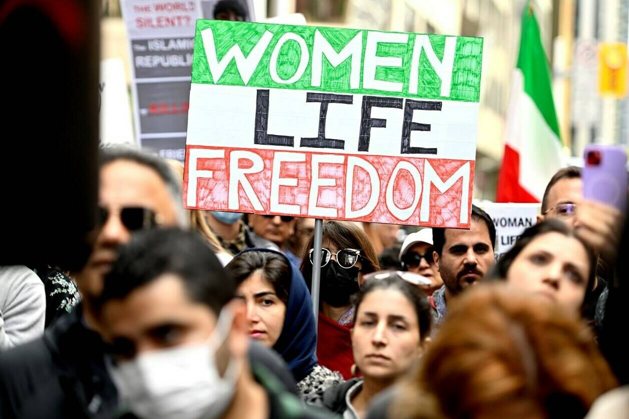 Members of the Iranian community and their supporters rally in solidarity with protesters in Iran, after 22-year-old Mahsa Amini died in police custody for allegedly improperly wearing a hijab, in Ottawa on Sunday, Sept. 25, 2022. Canada has sanctioned 25 senior Iranian officials and nine entities. Foreign Minister Mélanie Joly will also bar nine entities from doing business with Canadians.THE CANADIAN PRESS/Justin Tang