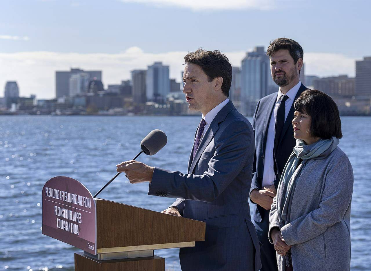 Prime Minister Justin Trudeau accompanied by Ginette Petitpas Taylor, right, minister responsible for the Atlantic Canada Opportunities Agency, and Sean Fraser, immigration minister, announces support for victims of post-tropical storm in Dartmouth, N.S. on Tuesday, Oct. 4, 2022. THE CANADIAN PRESS/Andrew Vaughan