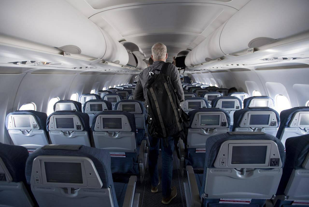A passenger gets off a flight from Vancouver to Calgary on Tuesday, June 9, 2020. THE CANADIAN PRESS/Jonathan Hayward