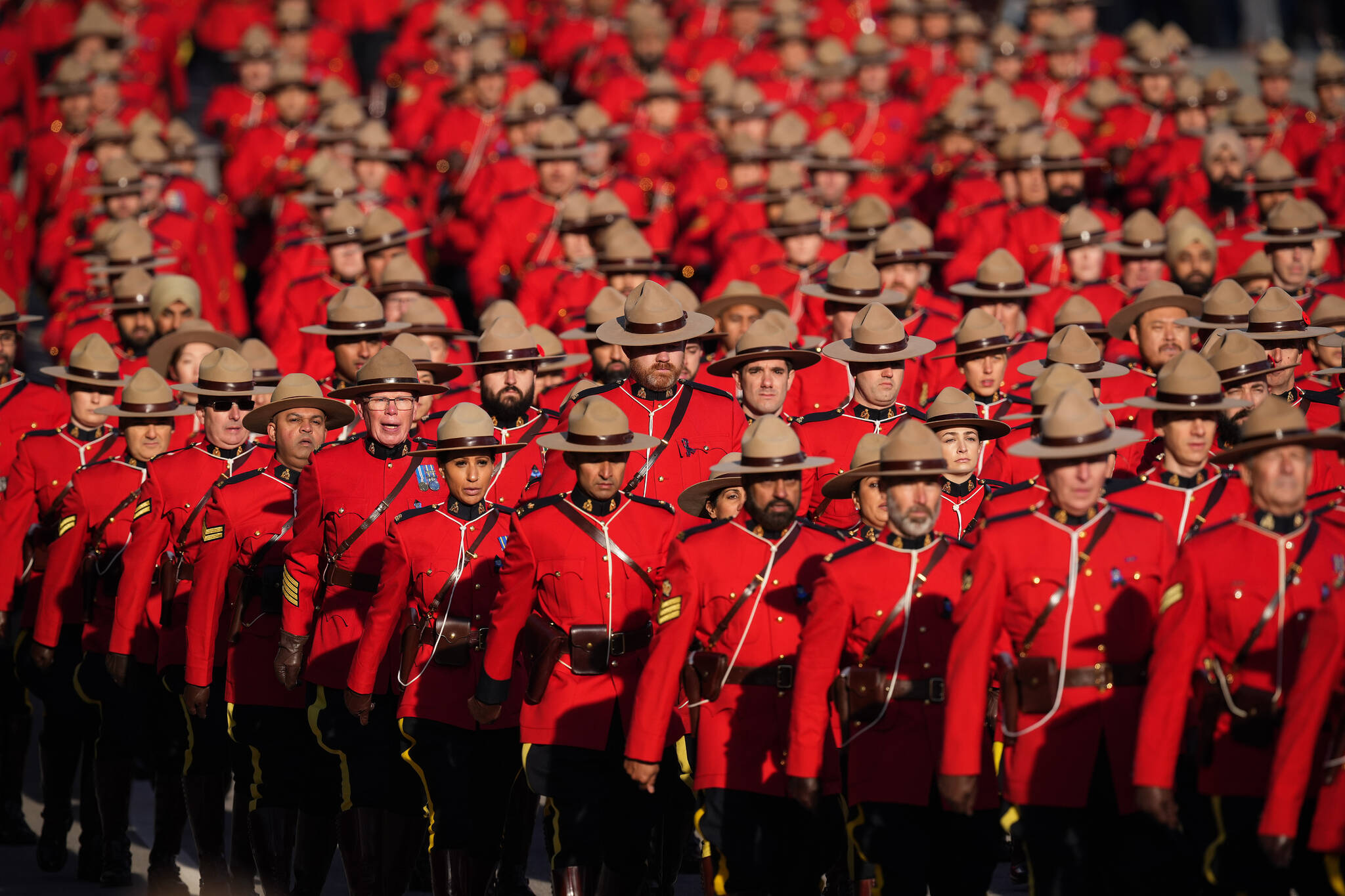 RCMP officers in red serge march to the regimental funeral for RCMP Const. Shaelyn Yang, in Richmond, B.C., on Wednesday, November 2, 2022. The 31-year-old officer was stabbed to death two weeks ago while she helped a City of Burnaby employee issue an eviction notice to a man living in a tent at a local park. THE CANADIAN PRESS/Darryl Dyck