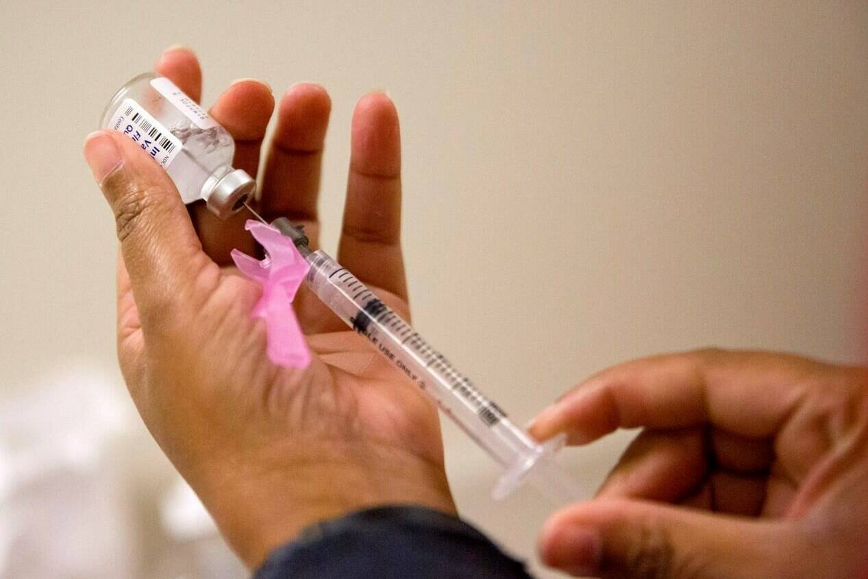 A nurse prepares a flu shot at the Salvation Army in Atlanta, Feb. 7, 2018. The B.C. Centre For Disease Control says there are signs influenza is on a “steady decline” in the province, although case numbers remain high and positive tests rates for respiratory syncytial virus continue to rise. THE CANADIAN PRESS/AP, David Goldman