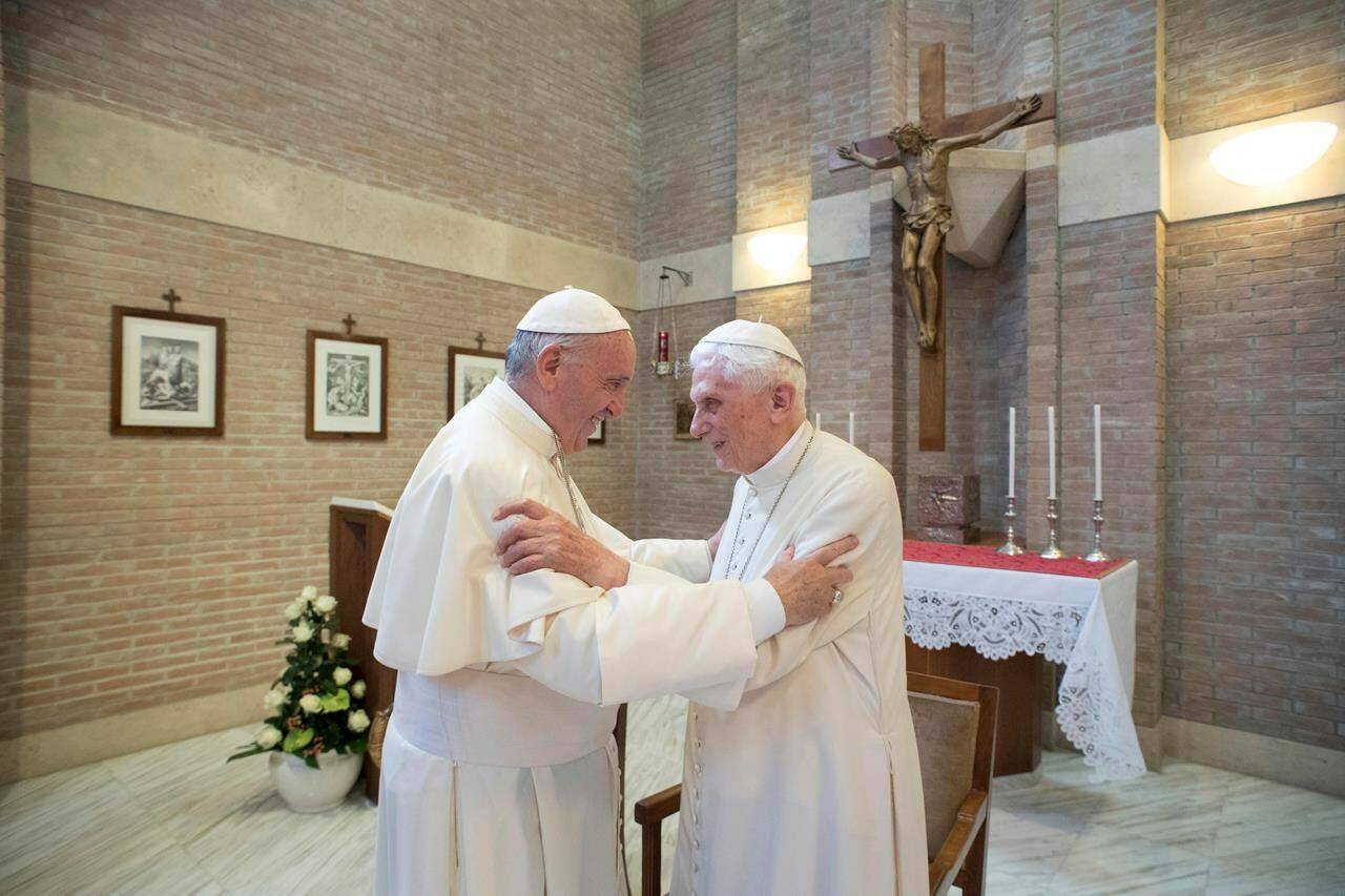 FILE - Pope Francis, left, embraces Emeritus Pope Benedict XVI, at the Vatican, June 28, 2017. Pope Francis on Wednesday, Dec. 28, 2022, said his predecessor, Pope Emeritus Benedict XVI, is “very sick,” and he asked the faithful to pray for the retired pontiff so God will comfort him “to the very end.” (L’Osservatore Romano/Pool Photo via AP, File)