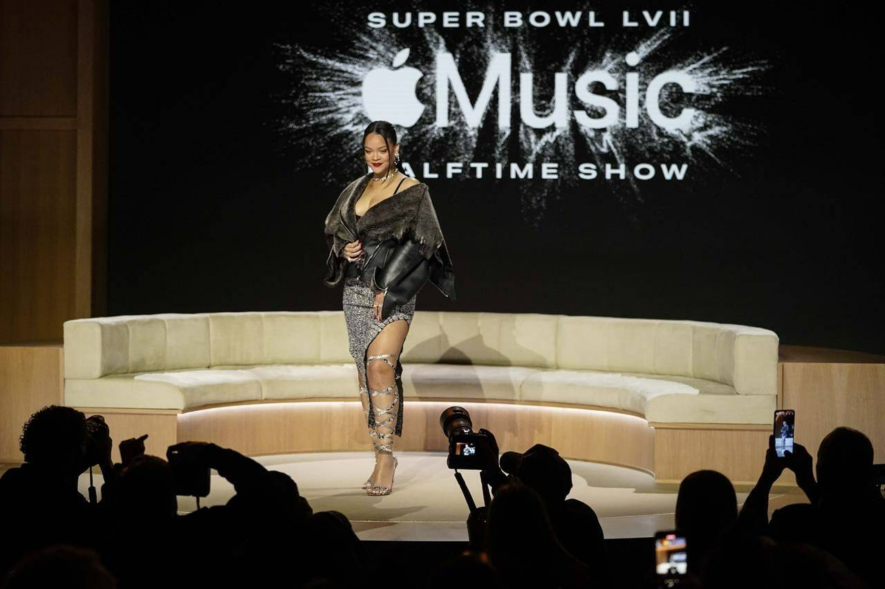 Rihanna poses for a photo after a halftime show news conference ahead of the Super Bowl 57 NFL football game, Thursday, Feb. 9, 2023, in Phoenix. (AP Photo/Mike Stewart)