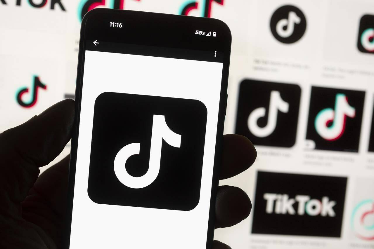 The TikTok logo is seen on a cell phone in Boston, Oct. 14, 2022. The federal government is banning TikTok from its mobile devices just days after federal and provincial privacy commissioners launched an investigation into the social media platform. THE CANADIAN PRESS/AP-Michael Dwyer