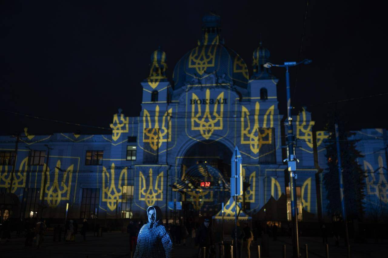 The train station in Lviv, western Ukraine, is lit up by Swiss artist Gerry Hofstetter, on Wednesday, Feb. 22, 2023. Ukrainian officials in Lviv say there’s another way Canadians can support the embattled country’s economy and war effort, but it’s not for the faint of heart: pack your bags and come be a tourist. THE CANADIAN PRESS/AP -Petros Giannakouris