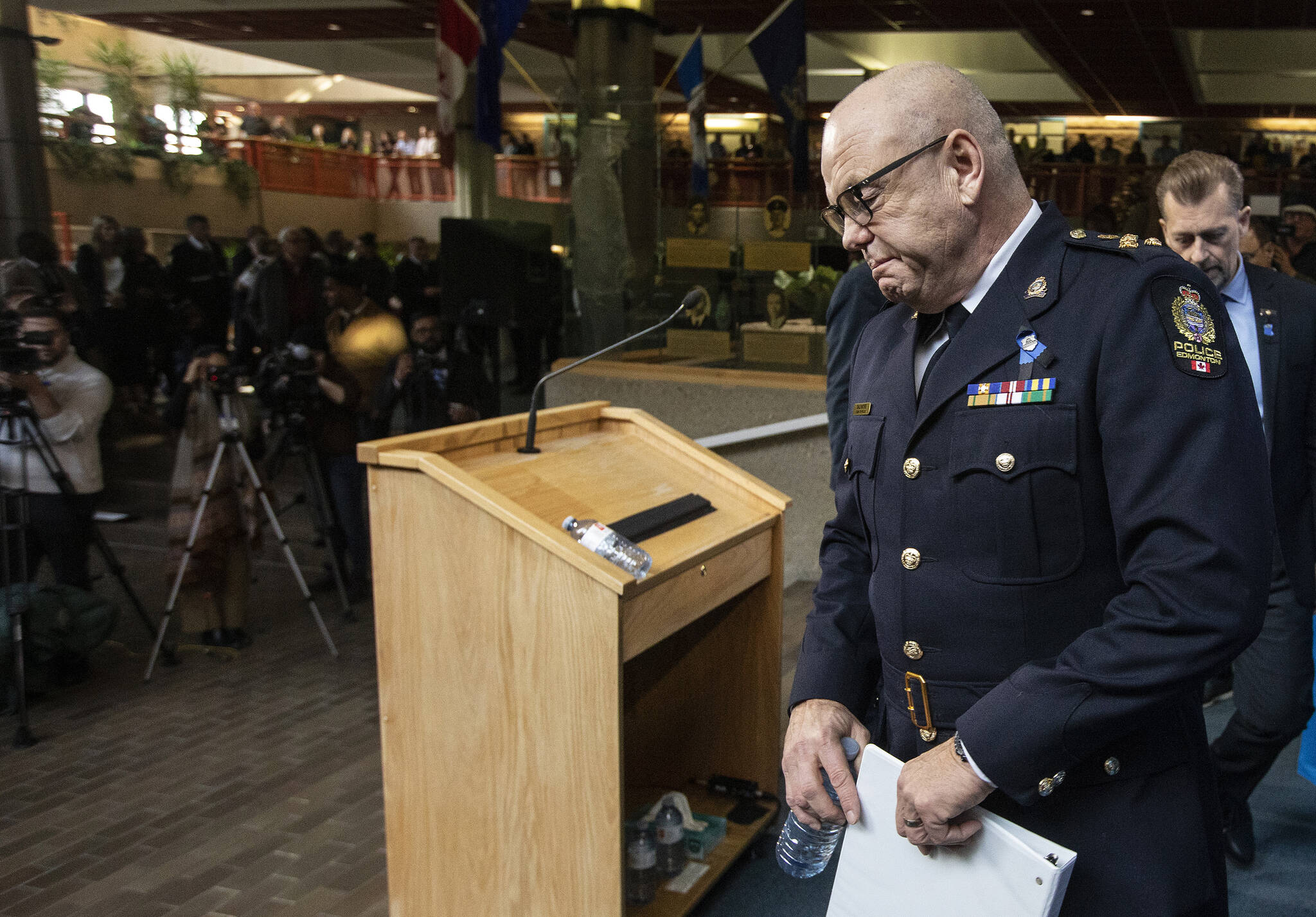 Edmonton Police Chief Dale McFee makes his way to speak to media about two police officers who were shot and killed on duty in Edmonton on Thursday, March 16, 2023. THE CANADIAN PRESS/Jason Franson