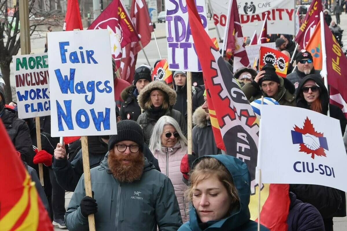 Members of the Public Service Alliance of Canada (PSAC) demonstrate outside the Treasury Board building in Ottawa on Friday, March 31, 2023. THE CANADIAN PRESS/ Patrick Doyle