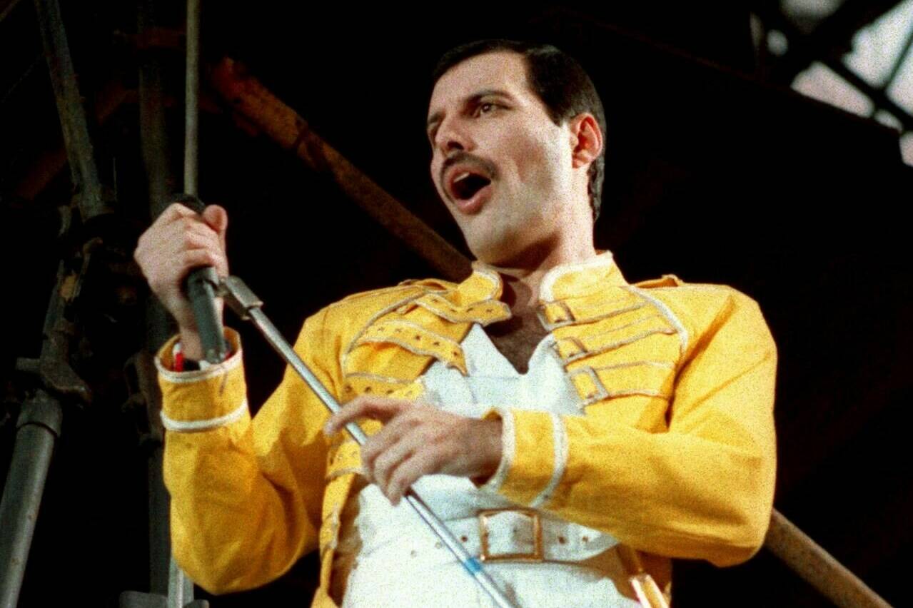 FILE - Queen lead singer Freddie Mercury performs, in Cologne, Germany, on Sunday, July 20, 1986 file photo. Freddie Mercury’s extensive collection of costumes, fine art, and even handwritten working lyrics to “We Are the Champions” will be auctioned in Sept. 2023. (AP Photo/Marco Arndt, File)