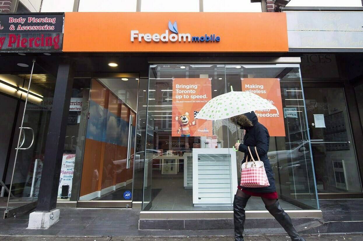 A woman walks past a Freedom Mobile in Toronto on Thursday, November 24, 2016. On the heels of the sale of Freedom Mobile, and amid an increased interest in unionization among retail and service workers, Teamsters Canada says retail and call centre employees at Freedom Mobile are looking to unionize.THE CANADIAN PRESS/Nathan Denette