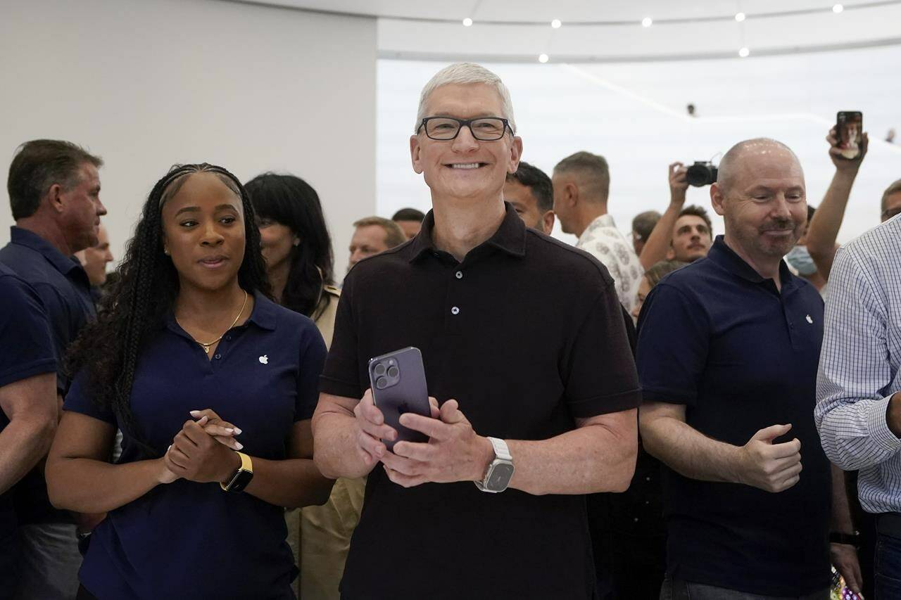 FILE - Apple CEO Tim Cook smiles at an Apple event in Cupertino, Calif., on Sept. 7, 2022. After ballooning for years, CEO pay growth is finally slowing. Cook, who was number three in the AP CEO pay survey, requested a 40% pay cut in 2023 after shareholders questioned the size and structure of his $99.4 million compensation package in 2022. (AP Photo/Jeff Chiu, File)