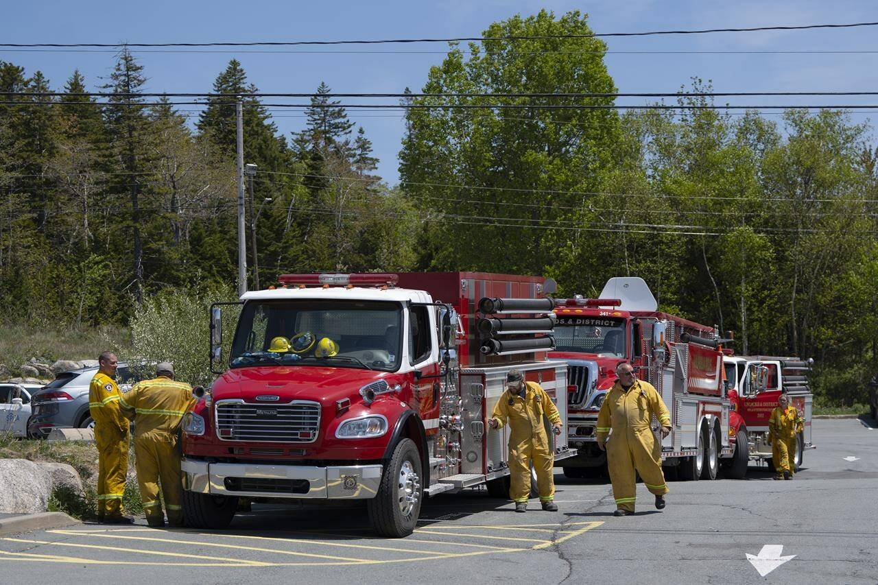 Firefighters arrive at a command centre within the evacuated zone while taking a break from battling the wildfire burning in Tantallon, N.S. outside of Halifax on Wednesday, May 31, 2023. Fighting wildfires in forested areas is a different exercise than battling blazes in urban dwellings, although experts say more places are seeing a crossover as people build houses on the fringes of wooded zones. THE CANADIAN PRESS/Darren Calabrese