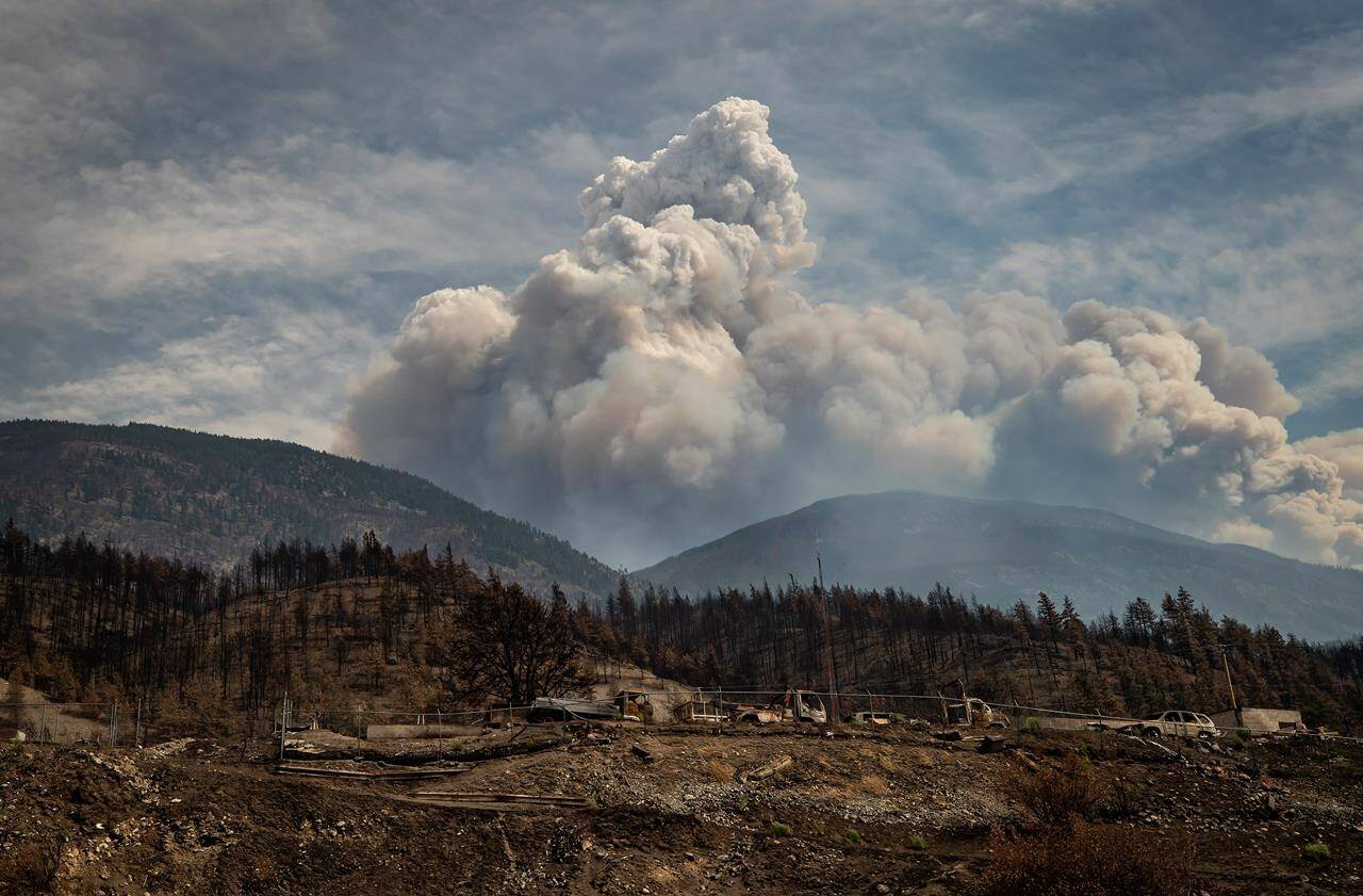 A pyrocumulus cloud, also known as a fire cloud, rises in the mountains above Lytton, B.C., on Sunday, Aug.15, 2021. Almost two years after it was first declared, the Village of Lytton has voted to end its State of Local Emergency. THE CANADIAN PRESS/Darryl Dyck