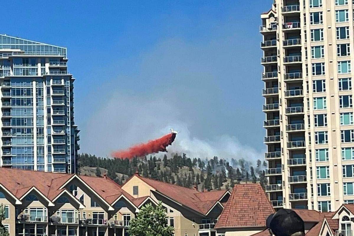 Retardant is shown being dropped from a plane on the Knox Mountain fire in Kelowna on Canada Day. B.C. Wildfire Service operations director Cliff Chapman said the call centre received more than 1,000 calls over the long weekend to report 46 new fires, which resulted in 35 of those being held or out. (Submitted)