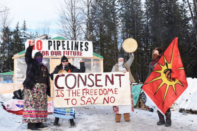 A group of pipeline opponents pictured at the encampment located just before the RCMP access control checkpoint at kilometre 27 of the Morice West Forest Service Road from Feb. 5, 2020. (File photo/Black Press Media)